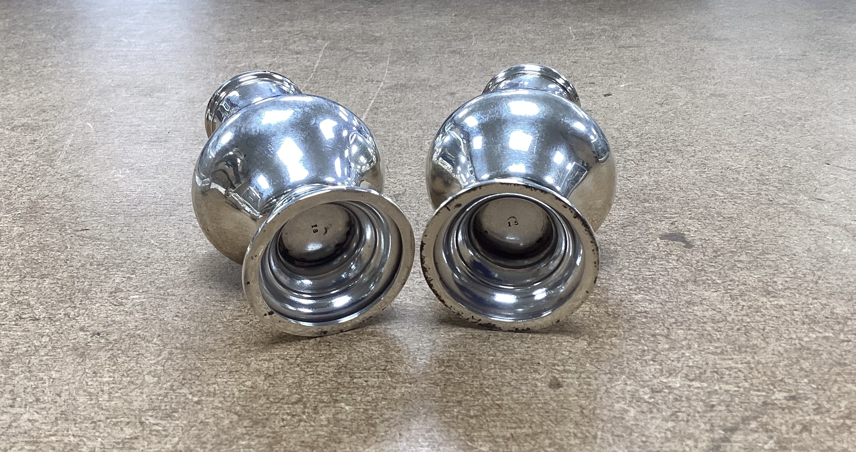 A matched pair of George V silver pepperettes, Chester 1912 and London, 1913, 12.3cm, 4.3oz.